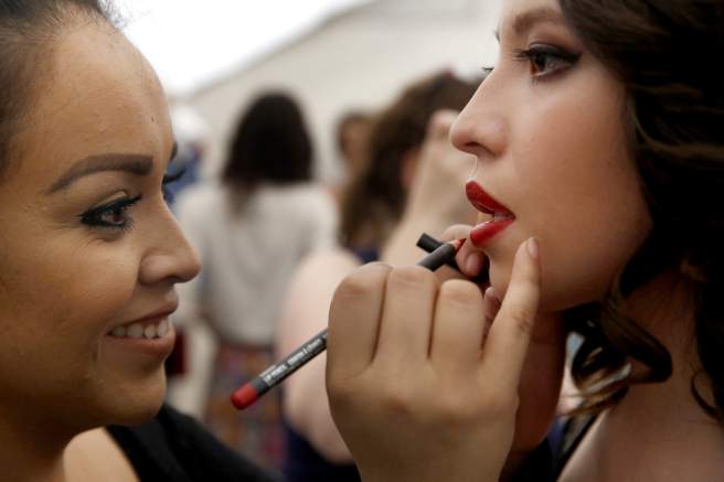 Lytle's Beauty College Student applying make up to a model at the Santa Rosa Junior College Fashion Show.